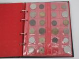 a red book with a bunch of coins inside of it