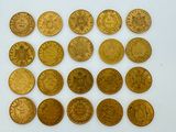 a close up of a bunch of gold coins on a white surface