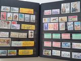 a black book with stamps on it that is open