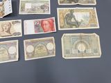 a lot of different bank notes on the table