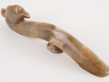 a small figurine of a bird on a white surface