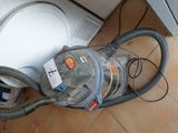a vacuum that is sitting on the floor next to a dishwasher