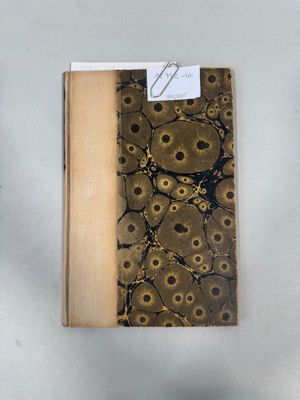 an open book with a brown cover sitting on top of a table