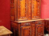 a large wooden cabinet and a small table in a room