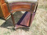 une petite table avec un plateau en verre posée sur l'herbe