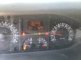 a close up of a dashboard with a clock on it