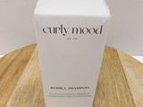 a box of curly mood shaming sham sitting on top of a wooden table