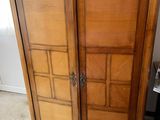 a wooden cabinet with a door on top of it