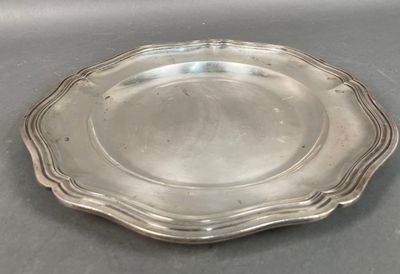 silver plate with scalloped edge on grey surface