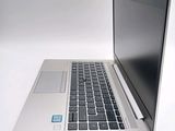 a silver laptop with a blue sticker on the screen