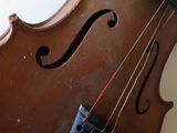 a close up of a violin with a string attached to it