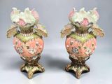 pair of pink and green vases with flowers and leaves on them