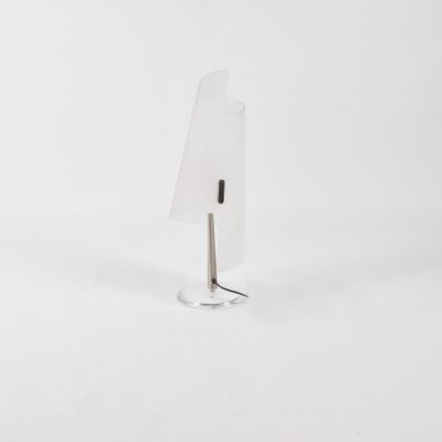 lamp in the shape of a triangle on a clear base with a metal stand