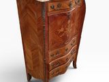 an antique chest of drawers with a marble top