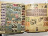 an open book with stamps on it on a table