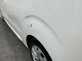 a white car that is parked on the side of the road