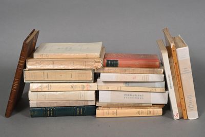 many books stacked on top of each other on a table