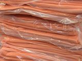 a pile of carrots that are wrapped in plastic