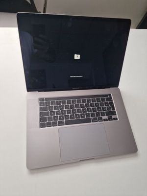 an apple laptop computer sitting on top of a white table