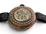a watch that is on a black leather strap