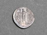 a close up of a silver coin with a woman on it