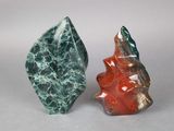 two pieces of green and red marble are sitting next to each other