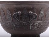 a large bronze bowl with a design on it