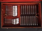 many forks and spoons in a wooden box