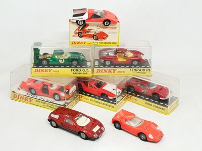 six toy cars in a display case on a white surface