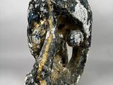 un gros plan d'une sculpture représentant un visage sur une surface blanche
