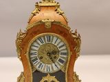 a clock that is sitting on a white table