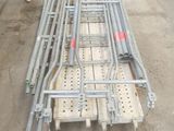 a pile of metal pipes and a cart on the ground