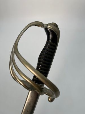 a close up of a sword with a curved handle