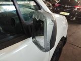 a broken mirror on the side of a white car