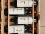 many bottles of wine sitting in a wooden box