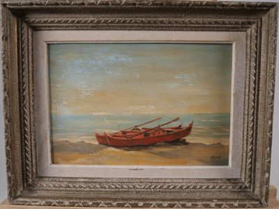 tableau représentant un bateau rouge sur une plage de sable, dans un cadre argenté