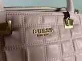 pink quilted handbag with gold hardware on the handle