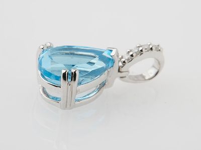 a blue topaz quartz and diamond pendant on a white background