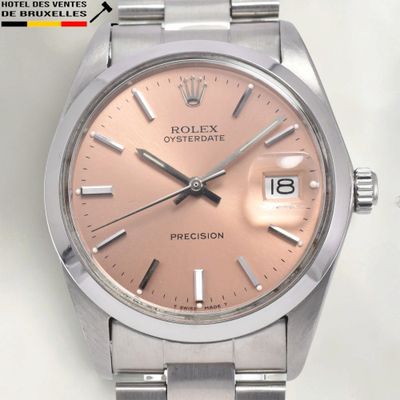 a watch that has a pink dial on it