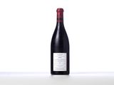 a bottle of red wine sitting on top of a table