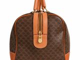 a brown and tan handbag on a white background