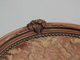 a close up of a chair with a floral design