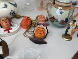 many figurines on a table with a teapot