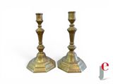 pair of antique brass candlesticks on a white background
