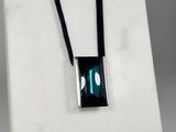 an image of a necklace with a green stone in the center