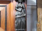 a statue of a woman holding a basket on top of a table