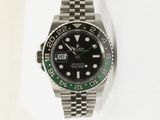 a rolex watch with a black dial and green bezel