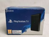 the box of the sony playstation tv is sitting on the table