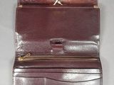 leather wallet with zippered closure on the inside of it