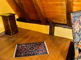 an image of a room with a bed and a rug on the floor